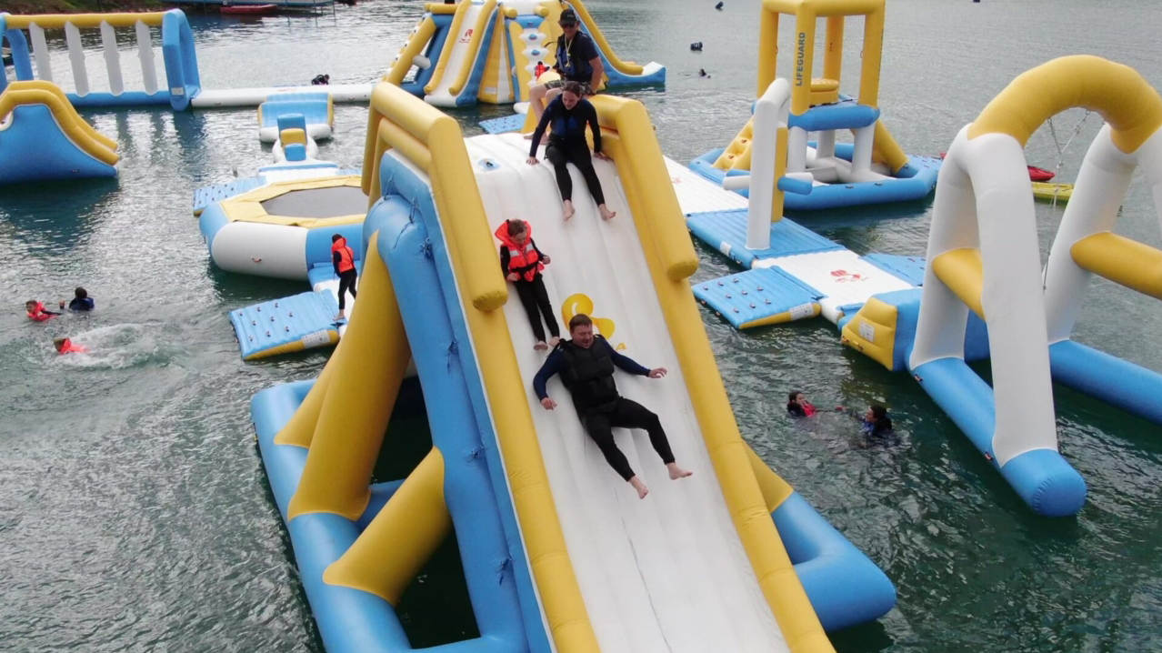 A family sliding down the inflatable slide