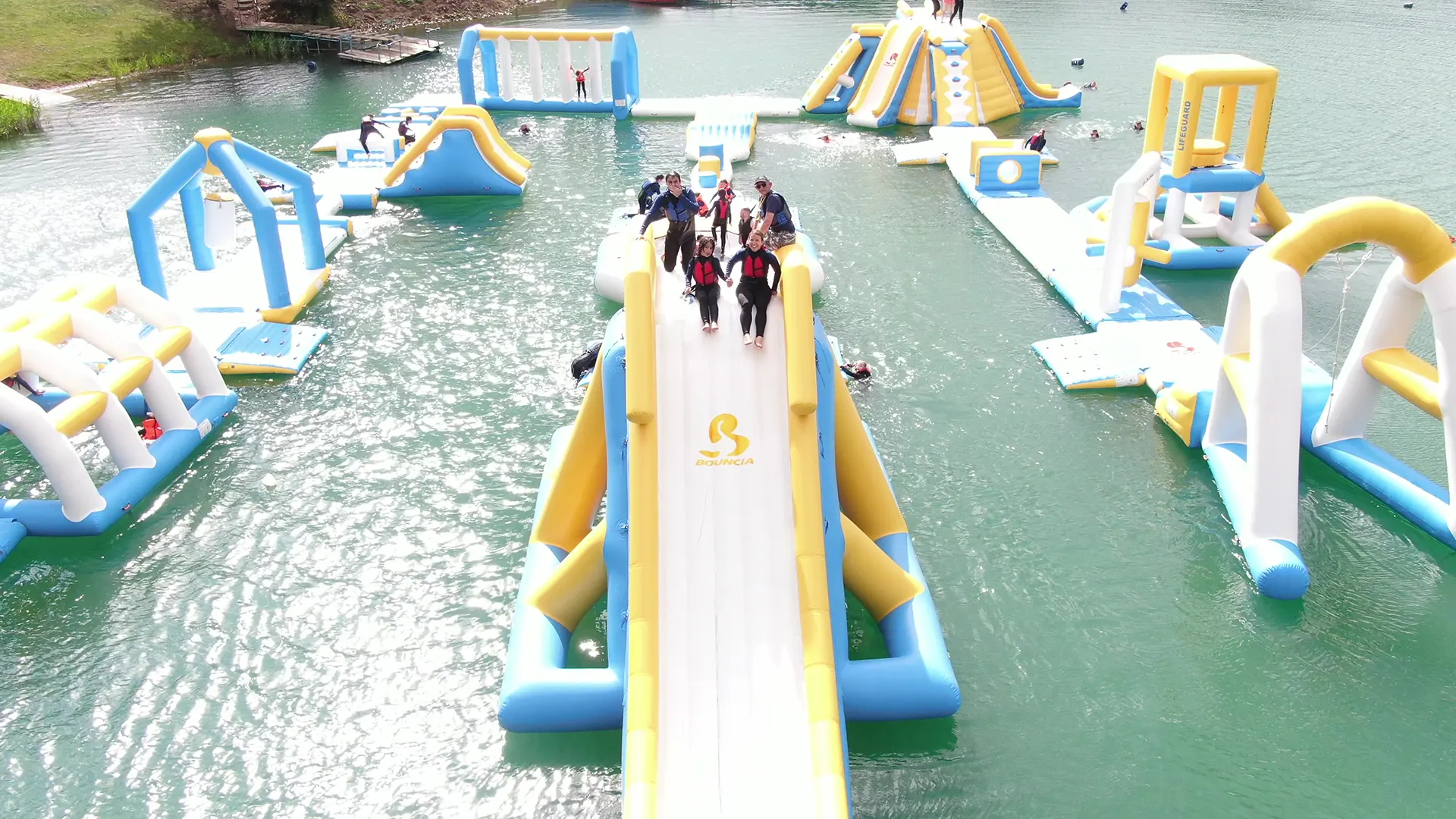 A group of aquapark users at the top of the slide