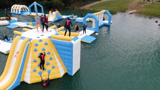 People climbing up the side of the inflateable high jump