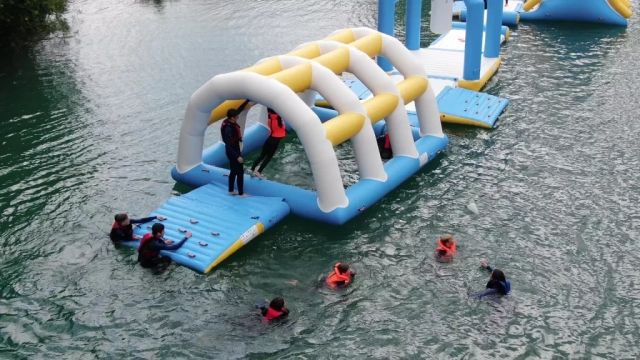 People swimming in the water next to the inflatables at Fenland Aquapark